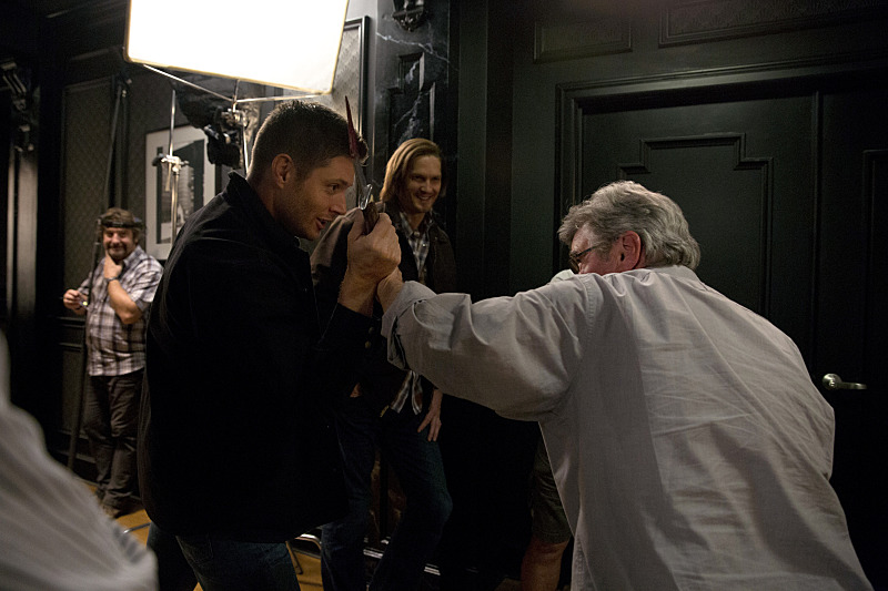 Supernatural -- "Girls, Girls, Girls" -- Image SN1007b_BTS_0048 -- Pictured: Behind the scenes with Jensen Ackles as Dean, Jared Padalecki as Sam, and Executive Producer and Director, Robert Singer -- Credit: Katie Yu/The CW --  ÃÂ© 2014 The CW Network, LLC. All Rights Reserved